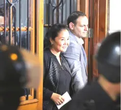  ??  ?? Keiko leaving the national criminal court in Lima with her husband Mark Vito, after being released from detention. — AFP photo