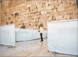  ?? Sebastian Scheiner The Associated Press ?? An ultra-orthodox Jewish man prays Wednesday ahead of the Jewish new year at the Western Wall, the holiest site where Jews can pray in Jerusalem’s old city. A raging coronaviru­s outbreak is casting a shadow over the normally festive Jewish New Year.