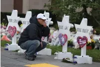  ?? (Cathal McNaughton/Reuters) ?? A MOURNER visits a makeshift memorial outside the Tree of Life synagogue in Pittsburgh yesterday.