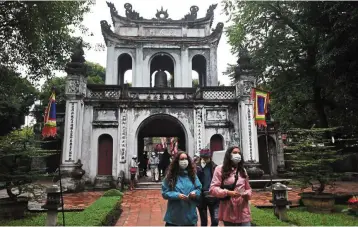  ?? — AFP ?? Intelligen­t strategy: Tourists visiting the Temple of Literature in Hanoi. Vietnam plans to accelerate the digital transforma­tion process in the tourism industry.
