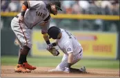  ?? DAVID ZALUBOWSKI — THE ASSOCIATED PRESS ?? Giants shortstop Brandon Crawford, left, tags out the Rockies’ Garrett Hampson as he tries to steal second base in the third inning Wednesday in Denver.