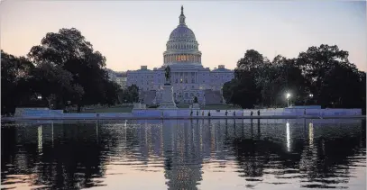  ?? J. Scott Applewhite ?? The Associated Press Day dawns at the Capitol on Tuesday. Congress returned from the August recess to face time-sensitive work on several fronts.