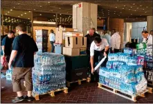  ??  ?? SUPPORT: Volunteers help to load up donations for survivors