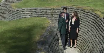  ??  ?? Richard Read, whose father was at Vimy Ridge, guides Trudeau and his wife, Sophie Grégoire Trudeau, through the trenches as they tour the former battlefiel­d.