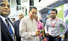  ??  ?? Speaker of Parliament Karu Jayasuriya examining a product at a stall PIX BY KITHSIRI DE MEL