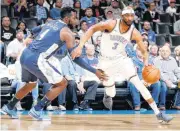  ??  ?? Oklahoma City’s Corey Brewer goes past Denver’s Paul Millsap during Friday’s game.