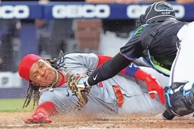  ?? WILFREDO LEE/THE ASSOCIATED PRESS ?? The Nationals’ CJ Abrams scores ahead of a tag from Marlins catcher Nick Fortes during the eighth inning Friday. Abrams and Trey Lipscomb scored on a single by Joey Meneses.