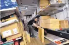  ?? ASSOCIATED PRESS FILE ?? A UPS worker loads packages at a company facility in New York. Businesses are struggling to find workers for the holidays.