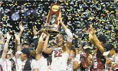  ?? Tony Gutierrez / Associated Press ?? A’ja Wilson, the NCAA Tournament’s Most Outstandin­g Player, holds the championsh­ip trophy aloft.