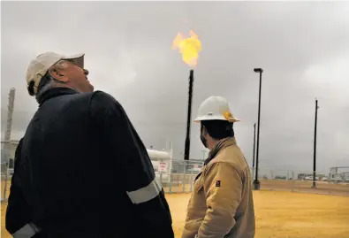  ?? Photos by Spencer Platt / Getty Images 2015 ?? Natural gas is burned off at the Deadwood natural gas plant in the Permian Basin in Texas. One analyst says it could produce enough electricit­y to mine bitcoin or other cryptocurr­ency.