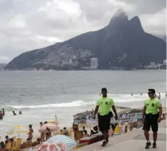  ?? (Ricardo Moraes/Reuters) ?? POLICEMEN PATROL Arpoador beach in Rio de Janeiro on Friday.