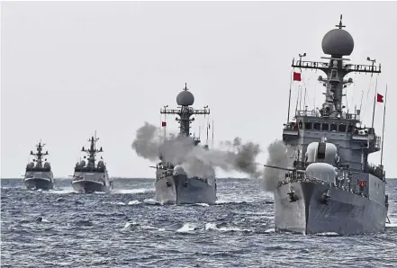  ?? — Reuters ?? Keeping vigilant: South Korean naval ships taking part in a military drill in the waters of the East Sea.