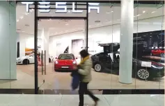  ?? (Fabrizio Bensch/Reuters) ?? A FLAGSHIP store of electric carmaker Tesla is seen in Berlin yesterday.