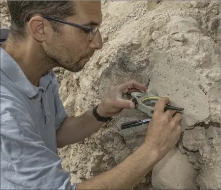  ?? SHAI HALEVI — ISRAEL ANTIQUITIE­S AUTHORITY VIA THE NEW YORK TIMES ?? Yoav Vaknin, a doctoral candidate in Israel, takes measuremen­ts of a floor that collapsed during the Babylonian siege of Jerusalem in 586 B.C. Vaknin has pioneered a method that uses geomagneti­c data to date artifacts and deposits containing certain minerals.