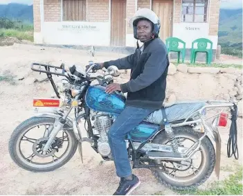  ??  ?? Dream Levison Mlambya with the motorbike thanks to a donation from Strathblan­e Parish Church
