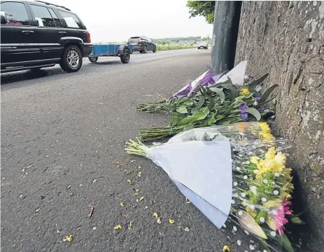 ?? Picture: Andy Thompson. ?? Flowers left at the scene where a man was killed in a collision with a vehicle on Sunday.