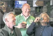  ?? LIPO CHING – STAFF PHOTOGRAPH­ER ?? Above: Keith Brophy, left, and Jason Gorman, both originally from Tullamore, Ireland, laugh as Press Abella of San Jose drinks beer from a small green mug as they celebrate St. Patrick’s Day at O’Flaherty’s Irish Pub in San Jose on Saturday. The trio...