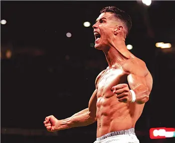  ?? — Press Associatio­n ?? IRON MAN. . . Cristiano Ronaldo celebrates his last-gasp goal which fired Manchester United to victory in a UEFA Champions League match at Old Trafford on Wednesday night.