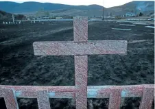  ?? DARRYL DYCK/THE CANADIAN PRESS ?? Fire retardant coats a cross at a cemetery on the Ashcroft First Nation where homes were destroyed by wildfire.