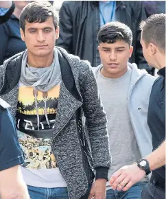  ??  ?? Young asylum seekers brought to Britain from the Jungle camp in Calais arrive at the Home Office Immigratio­n Centre in Croydon yesterday. A Ukip MEP said some looked too old to be children