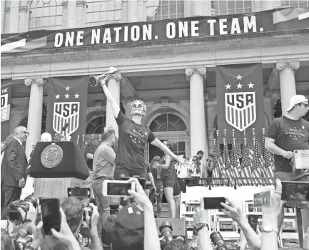  ??  ?? United States forward Megan Rapinoe celebrates Wednesday in New York after the ticker-tape parade to celebrate the Americans’ Women’s World Cup championsh­ip. BRAD PENNER/USA TODAY SPORTS