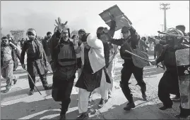  ?? [ANJUM NAVEED/THE ASSOCIATED PRESS] ?? Pakistani police officers beat a protester during a clash in Islamabad on Saturday.