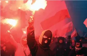  ?? JANEK SKARZYNSKI/AFP/GETTY IMAGES ?? Some 60,000 people, mostly men, took to the streets in Poland on Saturday to mark its Independen­ce Day. They waved banners reading, “Clean Blood,” “White Poland” and “Refugees get out!”