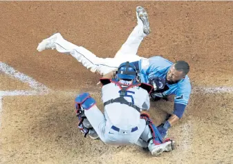  ?? Maxx Wolfson, Getty Images ?? Tampa Bay’s Manuel Margot s is tagged out by Austin Barnes of the Los Angeles Dodgers on an attempt to steal home during the fourth inning in Game 5 on Sunday.