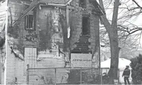  ?? ?? South Bend Fire Inspector Barry Sebesta stands outside the house at 222 N. LaPorte Ave. on Jan. 24 after Sunday’s fire where five children died inside the home.