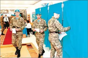  ?? STANISLAV FILIPPOV/AFP ?? Kazakh servicemen visit a polling station during Kazakhstan’s presidenti­al elections in Nur-Sultan on Sunday.