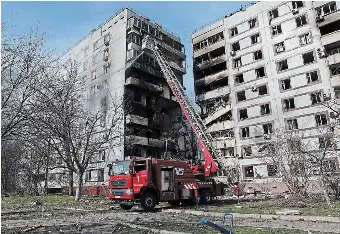  ?? KATERYNA KLOCHKO THE ASSOCIATED PRESS ?? A firefighte­r sprays water after a Russian missile hit a residentia­l multi-storey building in the southeaste­rn city of Zaporizhzh­ia, Ukraine on Wednesday.