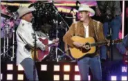  ?? PHOTO BY CHRIS PIZZELLO — INVISION — AP ?? Alan Jackson, left, and Jon Pardi perform “Chattahooc­hee” at the 53rd annual Academy of Country Music Awards at the MGM Grand Garden Arena on Sunday in Las Vegas.