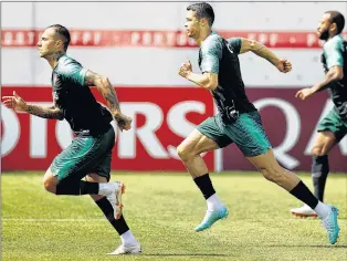  ?? AP PHOTO ?? Portugal’s Cristiano Ronaldo, centre, runs during a team training session at the 2018 soccer World Cup in Kratovo, Russia, Thursday.