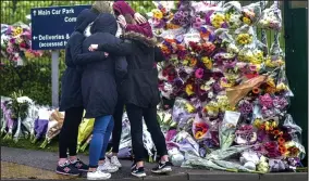  ??  ?? School in mourning: Pupils with floral tributes after the tragedy