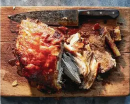 ?? Chris Simpson / New York Times ?? Pernil is marinated in garlic, citrus and herbs, then slow-roasted on high heat to achieve a crisp chicharrón.