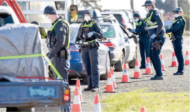  ??  ?? ↑
Police conduct roadside checks on the outskirts of Melbourne on Thursday.
Agence France-presse