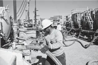  ?? James Durbin / Contributo­r ?? A commercial driver transporti­ng water makes a connection at a Conquest Completion Services coil tube operation in Reeves County.