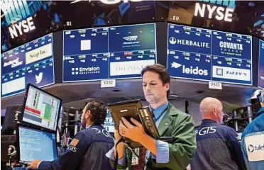  ?? — Bloomberg ?? Uptrend: Traders on the floor of the New York Stock Exchange. The S&P 500 Index of US shares has surged 12% this year, heading for its biggest annual gain since 2013.