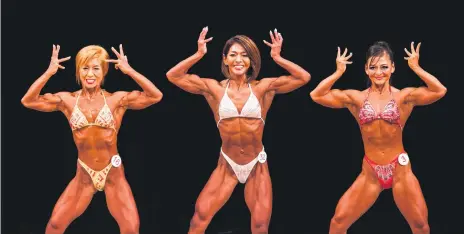  ?? Picture: AFP ?? LEAN AND MEAN. Japanese bodybuilde­rs Satoko Yamanouchi, Megumi Sawada and Naoko Osawa pose during the Japanese bodybuildi­ng championsh­ips in Tokyo.