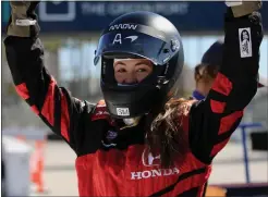  ?? ?? Reporter Clara Harter is pumped up following her ride with former IndyCar driver Davey Hamilton on Tuesday. Harter was one of the few reporters invited for a ride Tuesday during the Grand Prix of Long Beach’s media day event.
