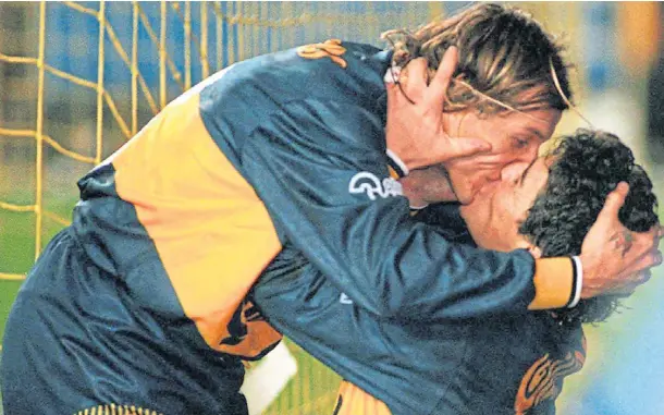  ??  ?? SPECIAL BOND: Claudio Caniggia and Diego Maradona embrace after the Dens legend scored for Boca Juniors against River Plate in July 1996.