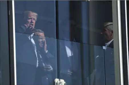  ?? SUSAN WALSH — THE ASSOCIATED PRESS ?? President Donald Trump watches the Presidents Cup golf tournament at the Liberty National Golf Course in Jersey City, N.J., Sunday. The President of the United States is the Honorary Presidents Cup Chairman.