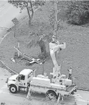  ?? [AP PHOTO] ?? Electrical workers repair and replace overhead lines Monday in Miami, Fla., in the wake of Hurricane Irma.