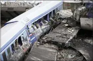  ?? GIANNIS PAPANIKOS - THE ASSOCIATED PRESS ?? Debris of trains lie on the rail lines after a collision in Tempe, about 376kilomet­res (235miles) north of Athens, near Larissa city, Greece, Wednesday, March 1. A passenger train carrying hundreds of people, including many university students returning home from holiday, collided at high speed with an oncoming freight train before midnight on Tuesday.