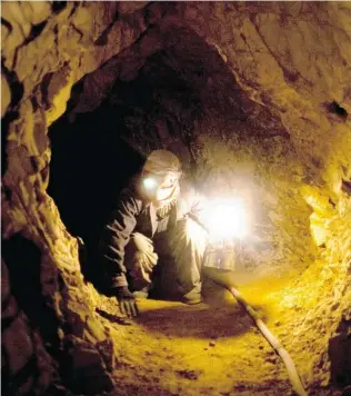  ?? MAJID SAEEDI/ GETTY IMAGES FILES ?? A miner works in a makeshift emerald mine in the Panjshir Valley. Reports suggest that Afghanista­n is sitting on significan­t deposits of oil, gas, copper, iron, gold, coal and precious gems.