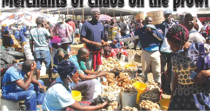  ??  ?? Shoppers buy sweet potatoes at Mbare Musika in Harare this week without observing social distancing to prevent the spread of coronaviru­s