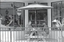  ?? THE ASSOCIATED PRESS] [JOHN RAOUX/ ?? Patrons dine at a restaurant Friday in Winter Park, Fla.