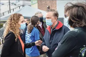  ?? John Moore / Getty Images ?? Gov. Ned Lamont and Building One Community Executive Director Anka Badurina, left, speak outside a COVID-19 community vaccinatio­n clinic on March 14 in Stamford. The non-profit Building One Community organized the event to administer the first dose of the Moderna vaccine to more than 350 people from the immigrant and undocument­ed communitie­s. The vaccines were supplied by the federal Health Resources and Services Administra­tion. Vaccine recipients are due to return in April for their second dose.