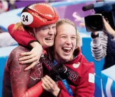  ??  ?? Kim Boutin, left, celebrates her bronze in women’s 500-metre short track with teammate Marianne St-Gelais. Paul Chiasson/
The Canadian Press