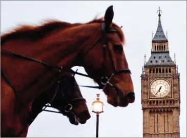  ?? JUSTIN TALLIS/AFP ?? Horses canter past Big Ben and the Houses of Parliament in London yesterday, ahead of the government’s Spring Budget announceme­nt. British Finance Minister Philip Hammond unveiled his latest tax and spend plans yesterday in a budget expected to exude...